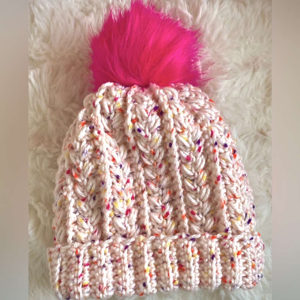 Hand made, crocheted children’s fun and colorful winter hat with pink pom pom